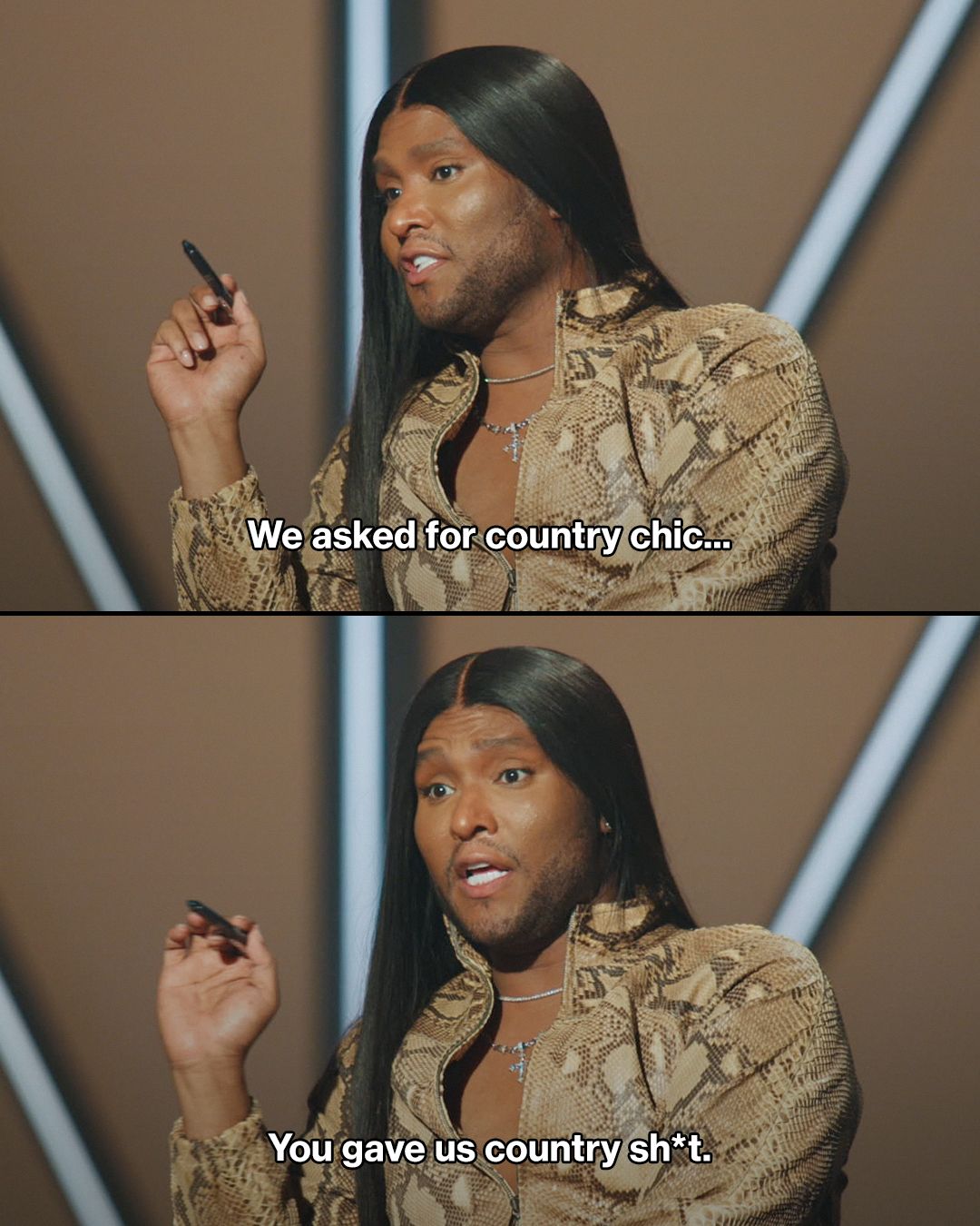 black man with long straight black hair wearing snake print jacket with a black pen in hand.